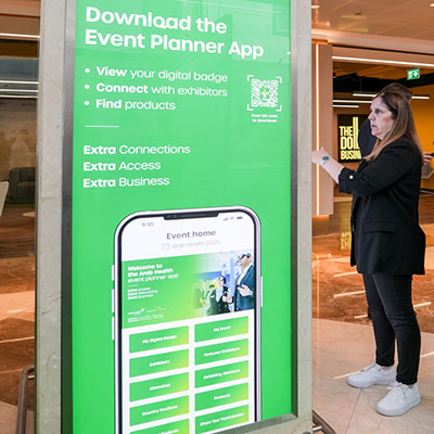 Attendee viewing the Event Planner App signage at WHX Dubai
