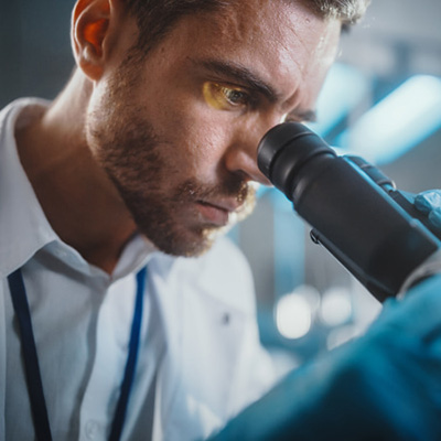 Doctor looking into a microscope