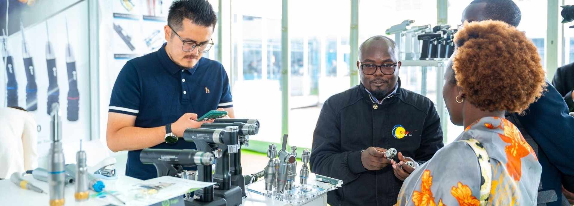 Exhibitors showing a medical device to attendees at World Health Expo Labs Nairobi